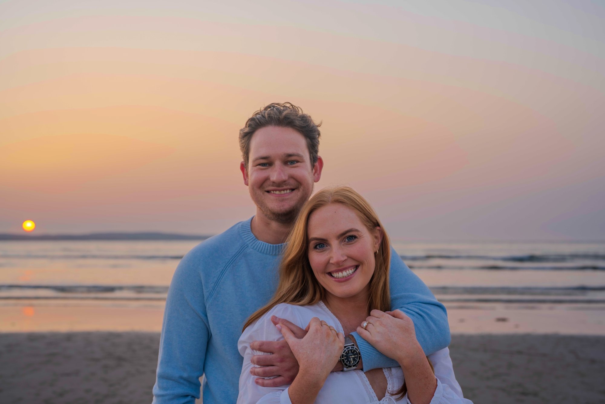 Laura and Andrew smiling at the beach